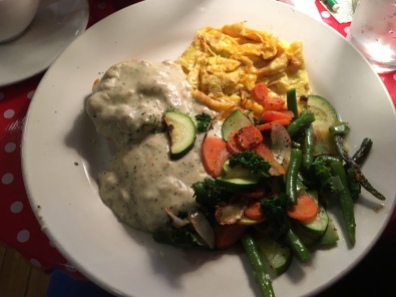 scrambled eggs with cheese, biscuit with soysaage gravy and sautéed vegetables