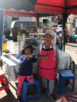 the vendor and her granddaughter at the encebollados stand